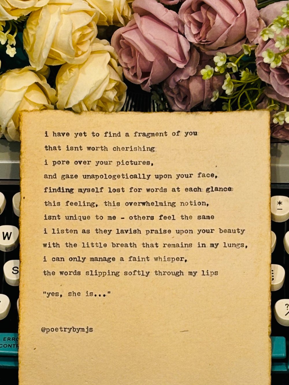 a typed poem resting among roses