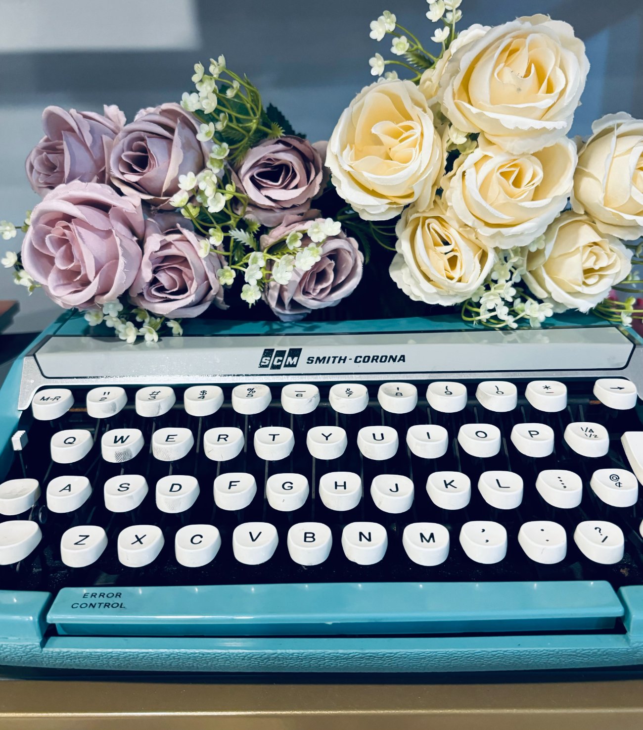 a vintage Smith-Corona typewriter with roses