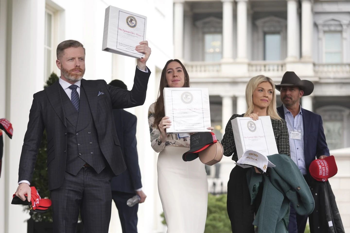 MAGA influencers hold up the 'Epstein files'